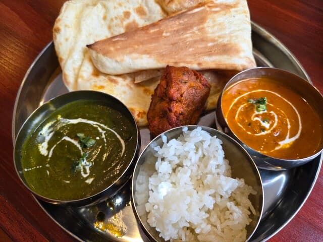 MOTHER INDIA set thali with palak curry, butter curry, chicken tikka, naan and rice